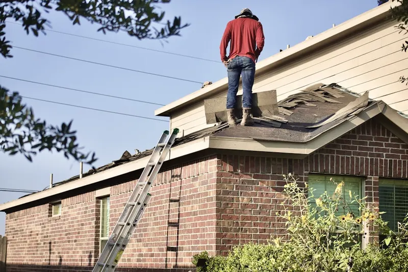 Professional roofer working on a residential roof in Kalama